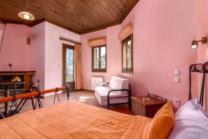 a bedroom with a bed and a chair and a fireplace at Zampakas Hotel Panorama in Stournaraíïka