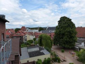 a large brick building with a tree on top of it at Hotel Altstadtwiege in Hameln