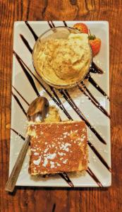 a plate of food with a dessert on a table at Uno Hotel Thames in Maidenhead