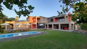 Oudtshoorn的住宿－Karoo Sun Boutique Guest House，享有带游泳池的房屋外部景致
