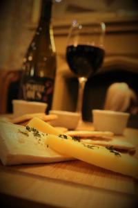 a wooden table with cheese and a glass of wine at The Bold Hotel; BW Signature Collection in Southport