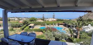 a view of the pool from the balcony of a resort at Artemis Village Apartments & Studios in Stavros