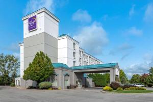 a large white building with a clock tower at Sleep Inn in Amherst