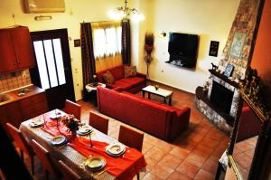 a living room with a couch and a table with chairs at Εlegant Villa Liakos in Pigi