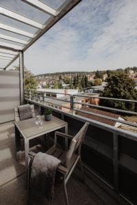 a balcony with a table and chairs and a view at Arivo Forchheim in Forchheim