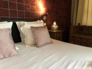 a bed with a white comforter and pillows at House of Bruges in Bruges