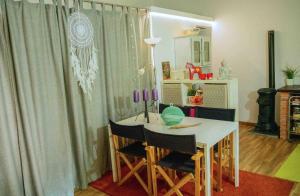 a room with a table and chairs and a mirror at Forest House casinha do Carvalhal in Vila Nova de Cerveira