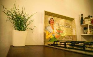 a picture of a woman on the wall next to a kitchen counter at Forest House casinha do Carvalhal in Vila Nova de Cerveira +22 photos