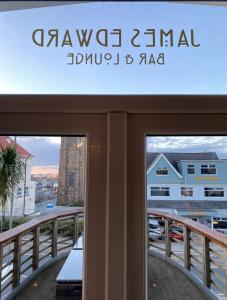 a sign for a building on a balcony at The White House Hotel in Newquay