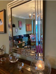 a mirror sitting on top of a wooden table at The White House Hotel in Newquay