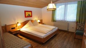 Postel nebo postele na pokoji v ubytování Appartementhaus Sennhüttn