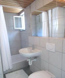 a bathroom with a sink and a toilet at Churfirsten Blick - Private Gästezimmer in Flums