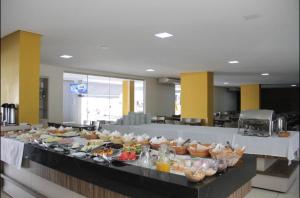 a buffet line with many different types of food at FLAT VEREDAS RIO QUENTE Apto 113 in Rio Quente