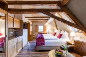 a bedroom with a king sized bed in a attic at Magdalenengut Studios und Suiten in Erfurt