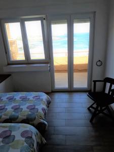 a bedroom with a bed and a view of the ocean at Loft with balcony sea view in Playa del Hombre
