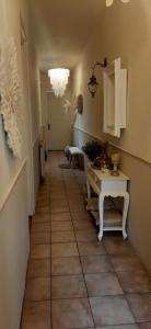 a hallway with a table and a chandelier at Hendrika Apartments in Zandvoort