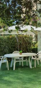 a picnic table with two chairs and an umbrella at Hotel Mediterraneo in Qualiano