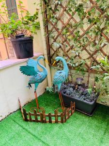 two blue birds standing in a wooden fence at Babyface in Rome