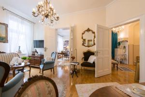 a living room filled with furniture and a chandelier at Apartament ASSER in Pszczyna