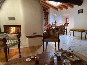 a living room with a fireplace and a table at Chalet Alpin in Val Cenis