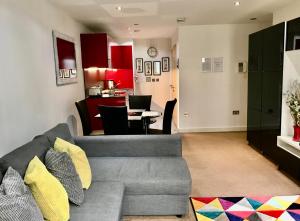 a living room with a gray couch and a table at Marsh House in Bristol