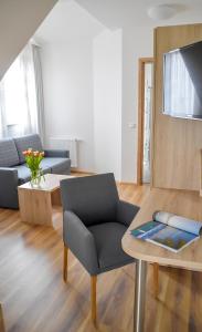 a living room with a couch and a table at Gasthof Krone Hotel & Restaurant in Friedrichshafen