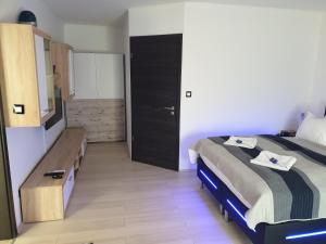 sypialnia z łóżkiem, komodą i lustrem w obiekcie Smaragd apartman w mieście Pecz