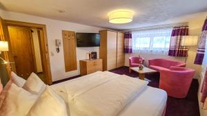 a hotel room with a bed and a chair at Apart Marlen in Ischgl