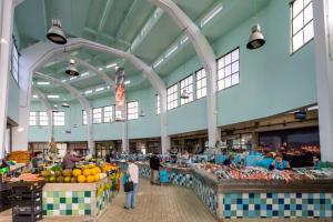 a market with many fruits and vegetables in a building at STUPENDO-One room concept-Center-Air conditioning in Lisbon