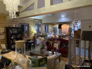 a living room with a couch and a table at Hôtel Bien-Être Aux Cyprès de Marquay in Marquay