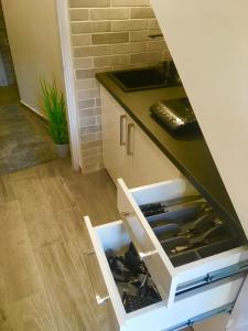 a kitchen with a drawer filled with wine bottles at Boróka Apartman Belváros in Veszprém