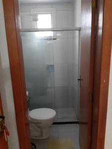 a bathroom with a toilet and a glass shower at Hotel Santiago in Salvador