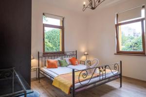 a bedroom with a bed with orange and green pillows at Entire Central House with Garden - 7 rooms, 5 bedrooms, 3 Baths in Sofia