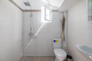 a white bathroom with a toilet and a sink at Entire Central House with Garden - 7 rooms, 5 bedrooms, 3 Baths in Sofia
