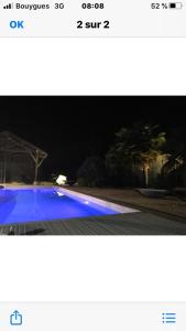 a picture of a blue swimming pool at night at Gîtes By Medoc in Bégadan