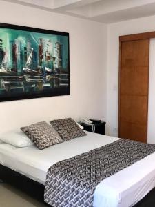 Ένα ή περισσότερα κρεβάτια σε δωμάτιο στο Apartamentos Cartagena Caribe Suite