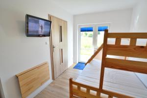 a room with a staircase with a television on a wall at Sofia Pokoje z łazienką i aneksem kuchennym in Jarosławiec +42 photos