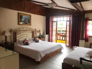 a bedroom with two beds and a window at Club Samawa in Santo Domingo de los Colorados