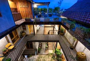 an overhead view of a building with stairs and a pool at Ruang Tekuni in Legian
