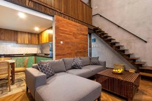 a living room with a couch and a table at Ruang Tekuni in Legian