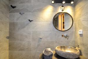 a bathroom with a sink and a mirror at Villa Marenosta in Ermoupoli