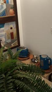 a table with two blue cups and a plant at Bienvenue chez Greg in Honfleur