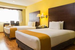 Postel nebo postele na pokoji v ubytování Hotel Madan Cárdenas