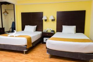 Postel nebo postele na pokoji v ubytování Hotel Madan Cárdenas