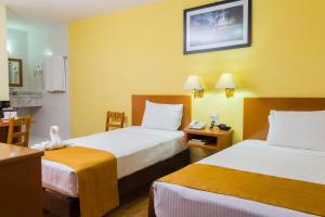 Postel nebo postele na pokoji v ubytování Hotel Madan Cárdenas