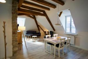 a living room with a table and chairs and a couch at Bärengasse Apartments in Freinsheim
