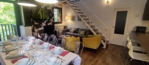 a dining room with a long table and a staircase at Pleta del Mon Atico in Benasque