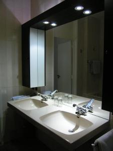 a bathroom with a sink and a large mirror at B&B Middelheim in Antwerp