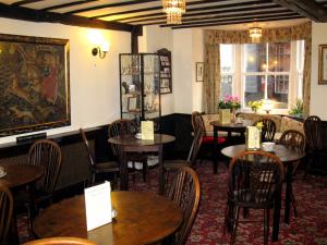 a restaurant with tables and chairs in a room at The Old Tea House in Dorchester