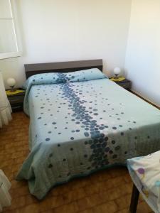 a bedroom with a bed with a blue comforter at Casa Zona Velha - Caetano in Funchal
